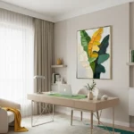 Contemporary hand-painted canvas featuring layered botanical leaves in golden yellow and deep green tones, modern workspace