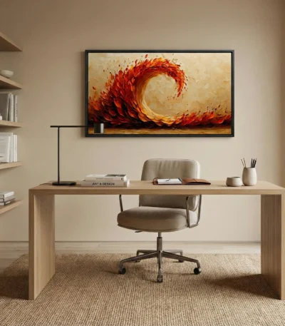 Gestural abstract hand-painted canvas depicting swirling flames in vibrant reds and golds, contemporary office setting