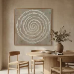 Textured abstract hand-painted canvas featuring concentric ivory spiral brushstrokes on muted taupe ground, contemporary dining space