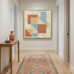 Textured abstract hand-painted canvas in terracotta, blue and ochre geometric blocks with layered paint, contemporary entryway
