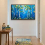 Textured contemporary landscape painting of white birch trees with golden foliage against deep blue background, modern entryway