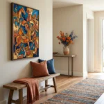 Gestural abstract expressionist hand-painted canvas depicting stylized horses and figures in vibrant orange, blue and ochre tones, contemporary entryway