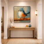 Contemporary figurative hand-painted canvas of a crested blue bird with orange breast on warm ochre branch, modern entryway