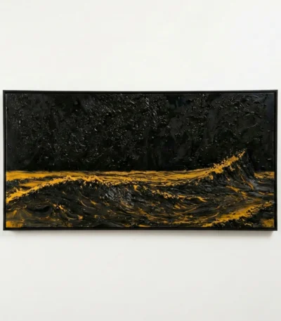 Textured abstract hand-painted canvas in deep black and golden ochre with gestural brushwork, white wall backdrop
