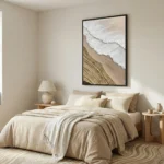Minimalist landscape hand-painted canvas depicting coastal waves and sandy shoreline in soft cream and taupe tones, modern bedroom