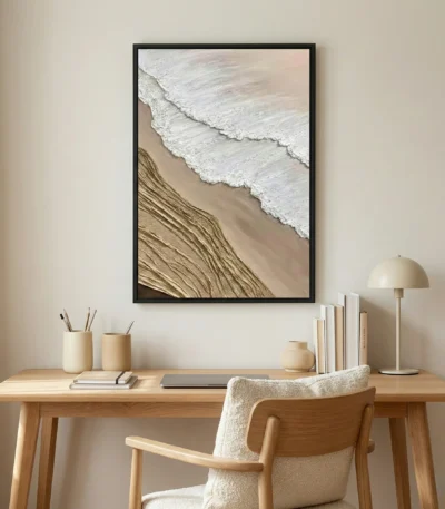 Contemporary landscape hand-painted canvas depicting coastal waves and sand patterns in cream and taupe tones, styled workspace