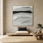 Gestural abstract hand-painted canvas with layered horizontal brushstrokes in cream, gray, and black, contemporary interior setting