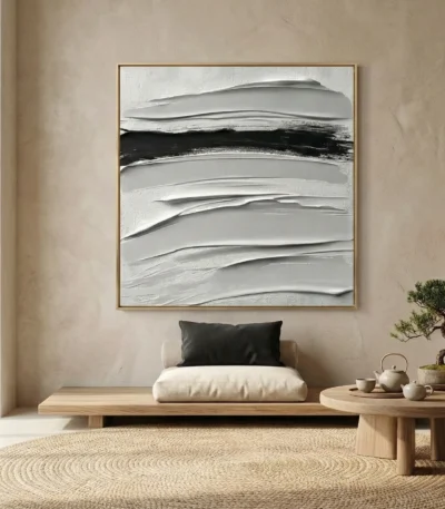 Gestural abstract hand-painted canvas with layered horizontal brushstrokes in cream, gray, and black, contemporary interior setting