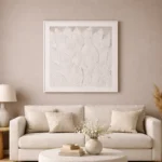 Textured minimalist hand-painted canvas depicting layered white feather forms in monochromatic tones, contemporary living space