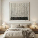 Minimalist abstract hand-painted canvas in charcoal and cream with vertical linear marks, modern bedroom setting