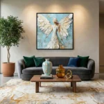 Textured figurative hand-painted canvas depicting an angel with cream and gold wings against soft blue, contemporary living space
