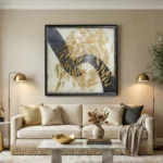 Contemporary abstract hand-painted canvas with layered black, gold, and cream gestural marks, modern living space