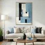 Layered abstract hand-painted canvas in blue, cream, and black geometric forms, contemporary living space