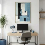 Layered abstract hand-painted canvas in blue, cream and black geometric blocks with textured brushwork, modern home office
