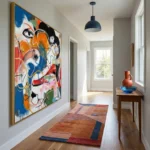 Gestural abstract expressionist hand-painted canvas with vibrant multicolored facial features and dynamic brushstrokes, blue red orange palette, modern hallway