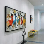 Gestural figurative hand-painted canvas depicting dancing figures in vibrant red, blue, and yellow tones, contemporary gallery space