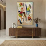 Gestural abstract hand-painted canvas with layered brushstrokes in vibrant reds, blues, yellows and earth tones, contemporary entryway