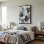 Gestural abstract hand-painted canvas in layered blue, cream, and charcoal brushstrokes, modern bedroom setting