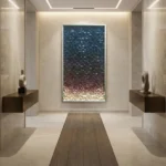 Textured abstract hand-painted canvas with gradient pixelated squares transitioning from deep teal to warm cream tones, contemporary gallery space