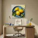 Contemporary still life hand-painted canvas depicting three vibrant lemons on blue plate, yellow and blue palette, home office setting