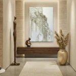 Textured abstract hand-painted canvas in cream and ivory tones with layered relief detail, modern entryway