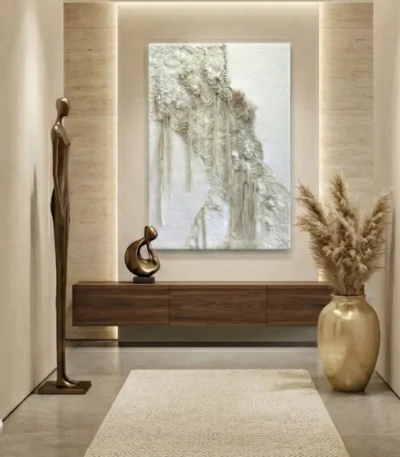 Textured abstract hand-painted canvas in cream and ivory tones with layered relief detail, modern entryway