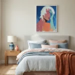Contemporary figurative hand-painted canvas portraying profile of figure with white hair in vibrant coral, blue and orange tones, modern bedroom