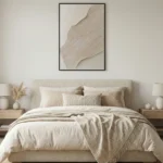 Minimalist abstract hand-painted canvas in layered cream and taupe tones with gestural brushwork, modern bedroom setting