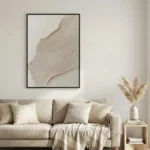 Textured abstract hand-painted canvas in layered cream and taupe tones with organic flowing forms, contemporary living space