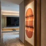 Minimalist hand-painted canvas featuring organic oval forms in warm terracotta and burnt orange tones, contemporary living space