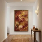 Gestural abstract expressionist hand-painted canvas in warm terracotta, gold and burgundy brushstrokes, contemporary entryway