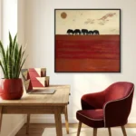 Minimalist landscape hand-painted canvas depicting silhouetted elephants against warm terracotta and cream horizon with sun, contemporary workspace
