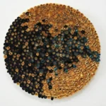 Textured abstract wall art composed of concentric metallic rings in gold, copper, and teal tones, hand-finished canvas