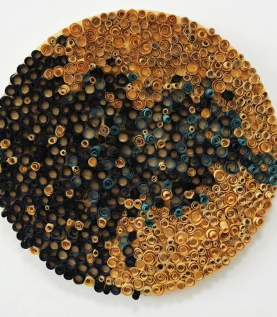 Textured abstract wall art composed of concentric metallic rings in gold, copper, and teal tones, hand-finished canvas