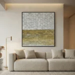 Textured abstract hand-painted canvas in layered cream and golden ochre horizontal bands, contemporary living space