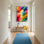 Gestural abstract hand-painted canvas in vibrant multicolored brushstrokes, layered in pinks, oranges, teals and yellows, modern entryway