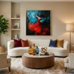 Gestural expressionist hand-painted canvas depicting a dancer in flowing red dress against deep blue brushstrokes, contemporary living space