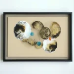Contemporary abstract hand-painted canvas with organic circular forms, textured earth tones and indigo accents, white wall backdrop