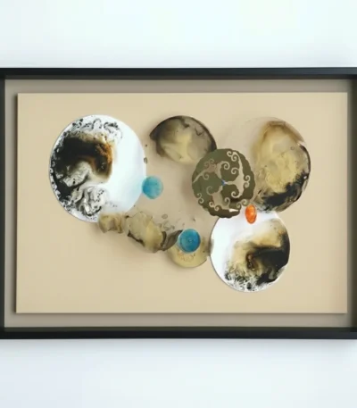 Contemporary abstract hand-painted canvas with organic circular forms, textured earth tones and indigo accents, white wall backdrop