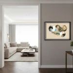 Layered abstract hand-painted canvas with gestural circular forms in cream, gold, and turquoise accents, contemporary hallway setting