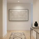 Minimalist abstract hand-painted canvas with geometric grid pattern and vertical lines in monochrome, contemporary hallway