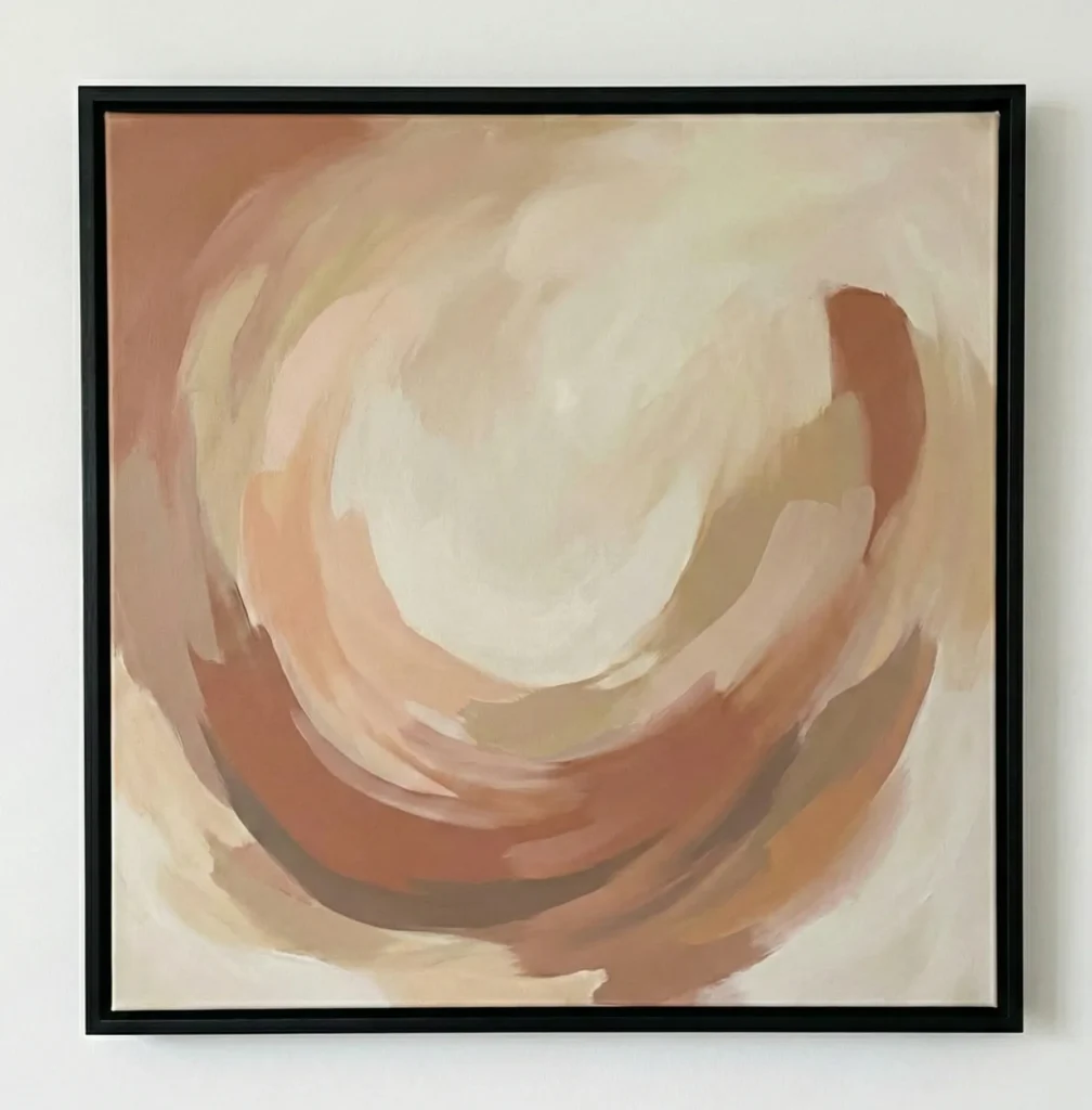 Gestural abstract hand-painted canvas in warm terracotta and cream tones with swirling concentric brushstrokes, contemporary living space