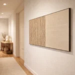 Minimalist hand-painted canvas with vertical line texturing in cream and natural wood tones, contemporary hallway