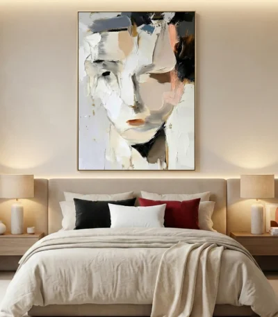 Expressionist hand-painted canvas depicting abstracted face in cream, white, and charcoal tones, contemporary bedroom