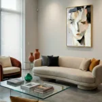 Gestural abstract hand-painted canvas depicting fragmented facial features in cream, charcoal and terracotta tones, contemporary living space