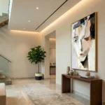 Contemporary abstract hand-painted canvas with gestural brushstrokes in cream, black, and terracotta tones, modern foyer setting