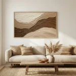 Layered abstract hand-painted canvas in cream and warm brown tones with flowing organic brushwork, contemporary living space