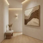 Textured abstract hand-painted canvas in layered cream, taupe, and chocolate tones with organic wave patterns, contemporary entryway