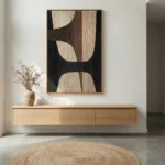 Abstract hand-painted canvas with organic curved shapes in charcoal, cream and taupe tones, modern entryway