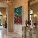 Textured abstract hand-painted canvas in layered green, taupe, and terracotta tones, classical interior setting